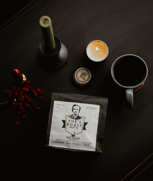 "Dark roasted coffee beans in a black mug with 'Poe's Roast' label"